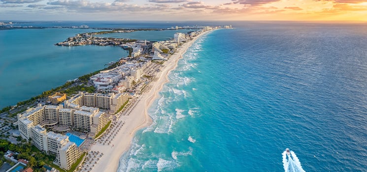 A beach with clear blue water and white sand in the Caribbean